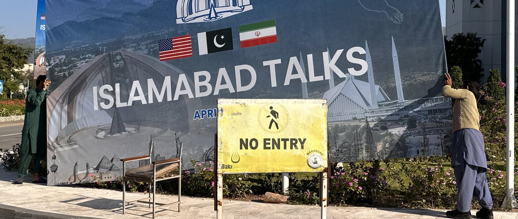 Workers remove billboards after the peace talks between U.S. and Iran ended in Islamabad, Pakistan, April 12, 2026. (EPA Photo)