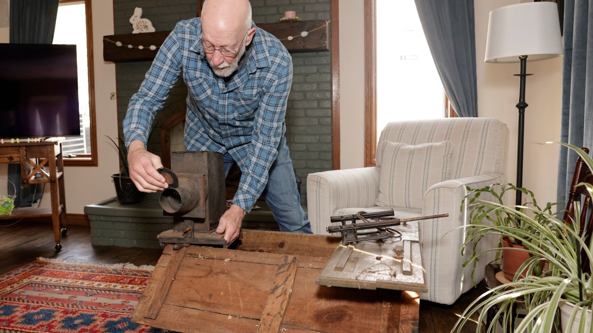 Bill McFarland holds his great-grandfather William DeLyle Frisbee's magic lantern slide projector at his home, Michigan, U.S., March 31, 2026. (AFP Photo)