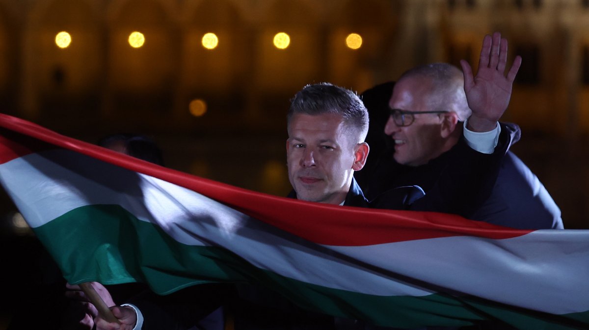 Tisza Party leader Peter Magyar waves a Hungarian flag after his party won a landslide victory in the general elections in Budapest, Hungary, April 12, 2026. (AA Photo)