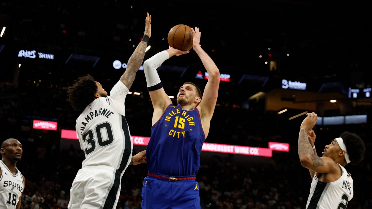 Nuggets' Nikola Jokic shoots over Spurs' Julian Champagnie during an NBA game in San Antonio, Texas, April 12, 2026. (AFP Photo)