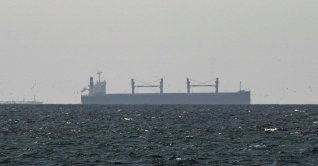 A cargo ship in the Gulf, near the Strait of Hormuz, as seen from northern Ras al-Khaimah, near the border with Oman’s Musandam governance, amid the U.S.-Israeli conflict with Iran, in the United Arab Emirates, March 11, 2026. (Reuters File Photo)