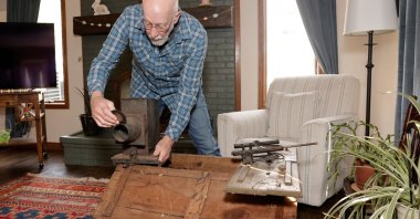 Bill McFarland holds his great-grandfather William DeLyle Frisbee's magic lantern slide projector at his home, Michigan, U.S., March 31, 2026. (AFP Photo)