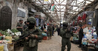 Israeli soldiers patrol through the market in the Old City of Nablus, Israeli-occupied West Bank, Palestine, April 12, 2026. (AFP Photo)