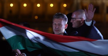 Tisza Party leader Peter Magyar waves a Hungarian flag after his party won a landslide victory in the general elections in Budapest, Hungary, April 12, 2026. (AA Photo)