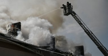Firefighters work at the site of a building hit by a Russian drone strike, amid Russia's attack on Ukraine, in Zaporizhzhia, Ukraine, April 13, 2026. REUTERS/Stringer 