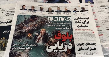 The front page of the Jam Jam newspaper on sale at a newsstand features a cartoon of U.S. President Donald Trump drowning in the Strait of Hormuz with the headline "Marine Bluff” in Tehran, Iran, April 13, 2026. (AFP Photo)
