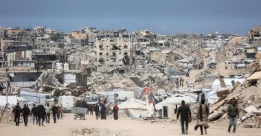 Palestinians walk amid the rubble of destroyed buildings in the Jabalia refugee camp in the northern Gaza Strip, April 13, 2026. (AFP Photo)