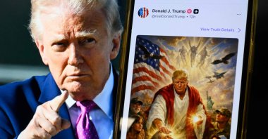 This photo illustration shows a picture of U.S. President Donald Trump on a screen and an AI-generated picture he posted on his Truth Social platform depicting himself as Jesus Christ after criticizing Pope Leo XIV, April 13, 2026. (AFP Photo)