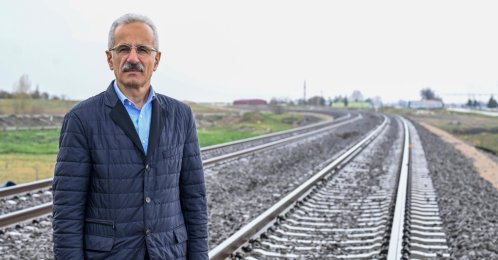 Transport Minister Abdulkadir Uraloğlu is seen next to a railway, Türkiye, April 13, 2026. (DHA Photo)