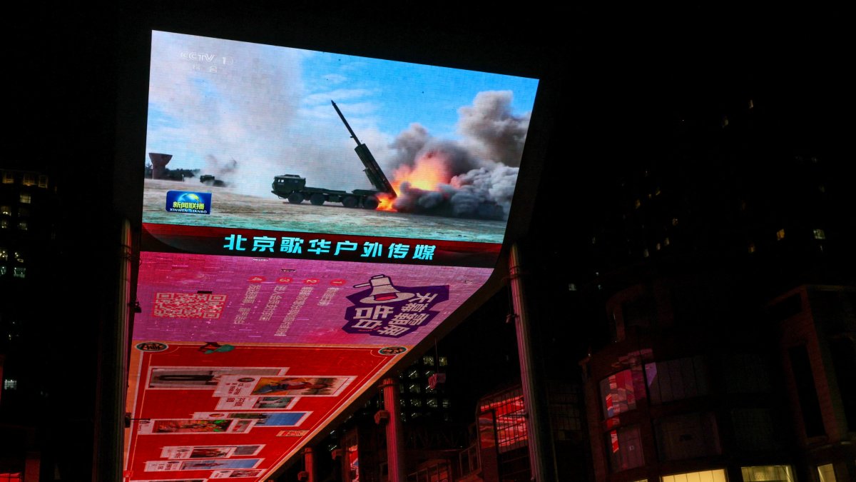 A giant screen shows a news report on China's "Justice Mission 2025" military drills around Taiwan, Beijing, China, Dec. 30, 2025. (Reuters File Photo)