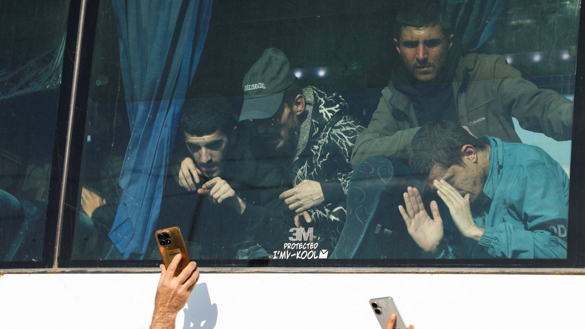 Former detainees held by the YPG look through a bus window as they arrive after being released under an agreement with the Syrian government, Hassakeh, Syria, April 11, 2026. (Reuters Photo)