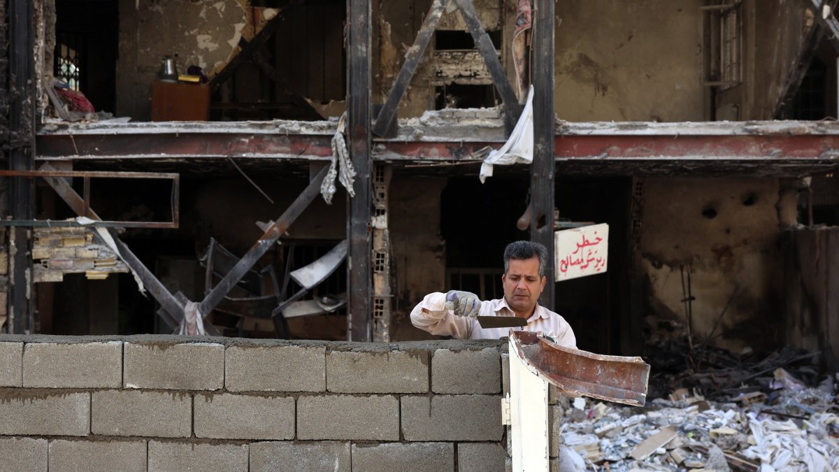 An Iranian worker works on a damaged residential building which was destroyed by U.S.-Israeli airstrikes in southern Tehran, Iran, April 14, 2026. (EPA Photo)