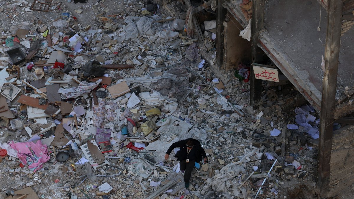 A member of the media works at the scene of residential buildings which were destroyed by U.S.-Israeli airstrikes at the Shahid Broujerdi residential complex in southern Tehran, Iran, April 14, 2026. (EPA Photo)