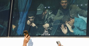 Former detainees held by the YPG look through a bus window as they arrive after being released under an agreement with the Syrian government, Hassakeh, Syria, April 11, 2026. (Reuters Photo)