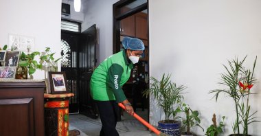 Laxmi, an employee with Pronto, cleans a house with a broom, New Delhi, India, March 23, 2026. (Reuters Photo)