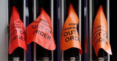"Out of order" signs cover fuel pumps at a petrol station, Sydney, Australia, March 19, 2026. (Reuters Photo)