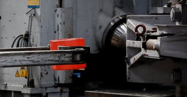 A worker moves a piece of glowing stainless steel during the rolling process during a press visit at Safran Aircraft Engines foundry and forgings plant, Gennevilliers, France, April 13, 2026. (Reuters Photo)