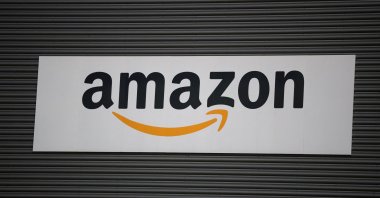 An Amazon logo outside an Amazon warehouse, Manchester, U.K., Oct. 28, 2025. (Reuters Photo)