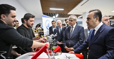 Industry and Technology Minister Mehmet Fatih Kacır (R) speaks with students at an event, Istanbul, Türkiye, April 13, 2026. (AA Photo)