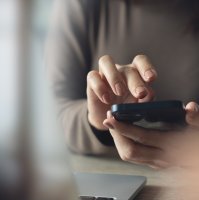 A woman using a mobile phone. (Shutterstock Photo)