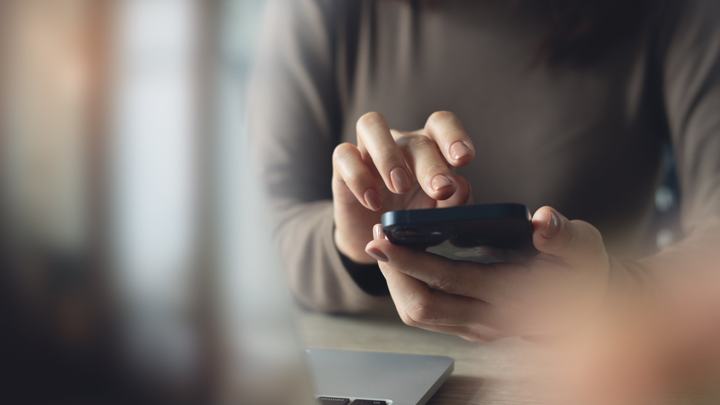 A woman using a mobile phone. (Shutterstock Photo)