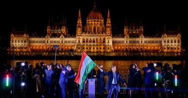 Peter Magyar, leader of the opposition Tisza party, holds a national flag following the partial results of the parliamentary election, Budapest, Hungary, April 12, 2026. (Reuters Photo)