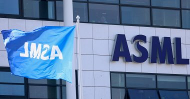 A flag and a logo at ASML offices in Veldhoven, Netherlands, March 24, 2026. (Reuters Photo)