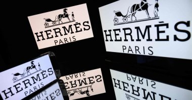 This illustrative photograph shows screens displaying the logo of the French company Hermes, listed on the CAC 40, the main stock market index of the Paris Stock Exchange, Toulouse, France, March 31, 2026. (AFP Photo)