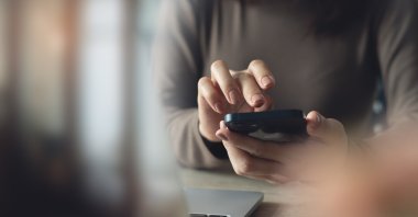 A woman using a mobile phone. (Shutterstock Photo)