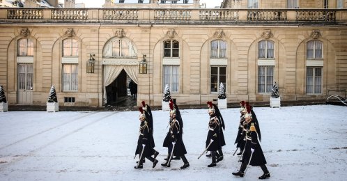 Republican Guards walk in the snow-covered courtyard of the Elysee Palace in Paris, France, Jan. 6, 2026. (AP Photo)