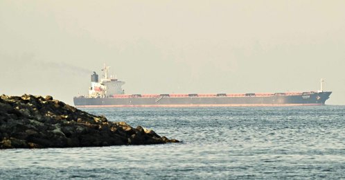 A cargo ship is pictured off the coast city of Fujairah in the Strait of Hormuz, United Arab Emirates, Feb. 25, 2026. (AFP Photo)