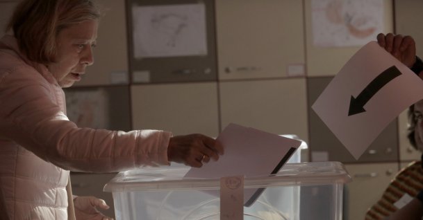 A woman holds her ballot at a polling station during the general elections, Sofia, Bulgaria, Oct. 27, 2024. (AP Photo)