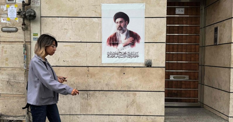 An Iranian woman walks past a poster featuring a portrait of Iran’s new Supreme Leader Mojtaba Khamenei, Tehran, Iran, April 13, 2026. (AFP Photo)