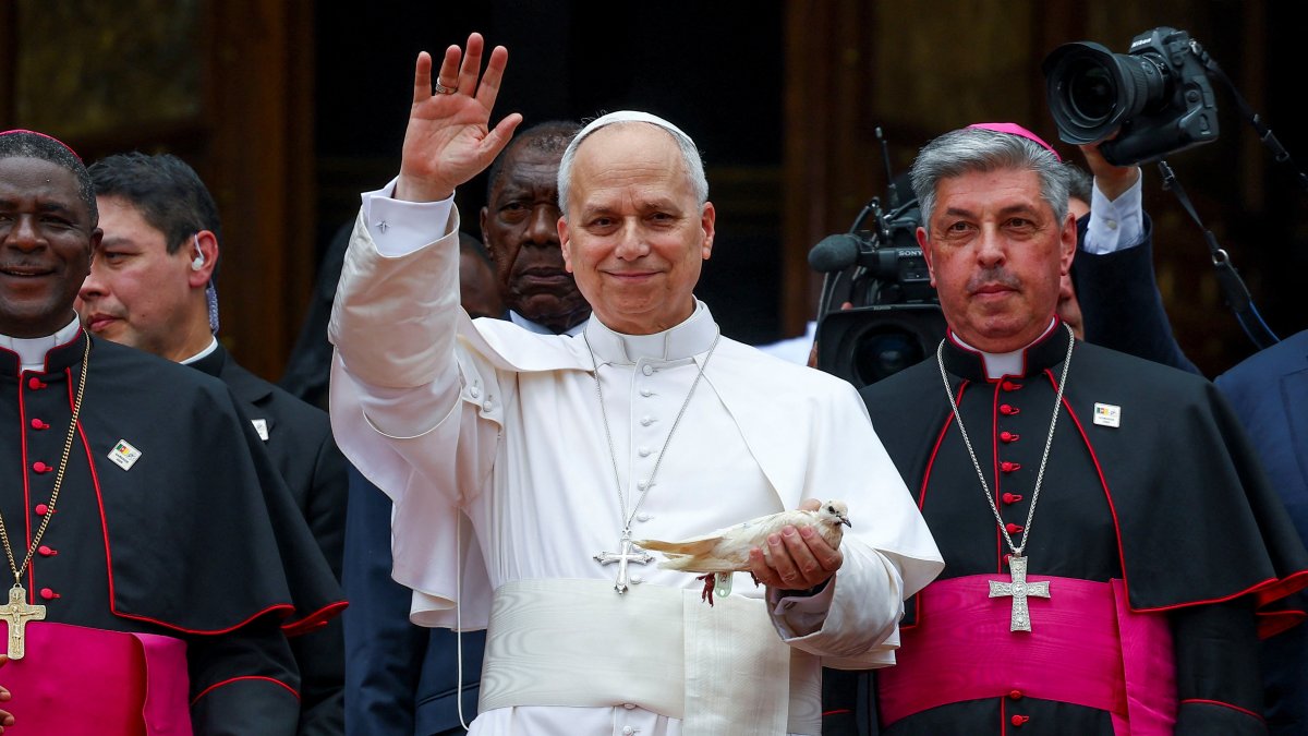 Pope Leo XIV waves as he holds a white pigeon at Saint Joseph’s Cathedral in Bamenda, Cameroon, April 16, 2026. (Reuters Photo)
