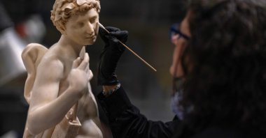 A conservator cleans the sculpture Apolo by Italian artist Silvio Cosini at the Prado museum's sculpture restoration department, Madrid, Spain, Oct. 23, 2025. (AFP Photo)