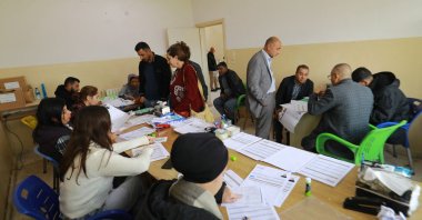 Forms are filled out as Syrian Kurds gather at a registration center for foreign Kurds and unregistered residents, al-Malikiyah, northeastern Syria, April 15, 2026. (AFP Photo)