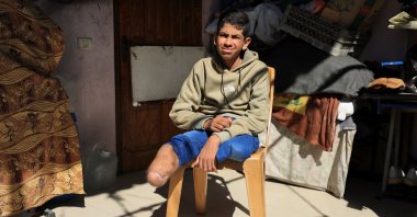 Fadel Al-Naji, 14, who lost both legs after being injured in an Israeli strike, sits at his home in Gaza City, April 10, 2026. (Reuters Photo)
