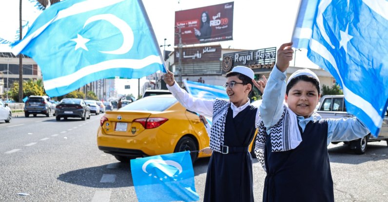 Children wave the Iraqi Turkmen flags as Iraqis go to the polls in the multi-ethnic city of Kirkuk, northern Iraq, Nov. 11, 2025. (AFP File Photo)