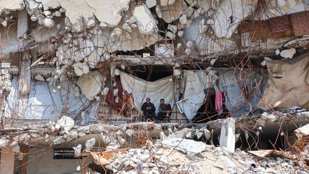 Displaced Palestinians sit outside a makeshift shelter amid the rubble of destroyed buildings at the Jabalia refugee camp in the northern Gaza Strip on April 13, 2026. (AFP Photo)