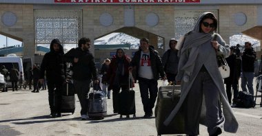 Iranians walk after crossing into Türkiye at the Kapıköy Border Gate, Van province, eastern Türkiye, March 3, 2026. (Reuters Photo)