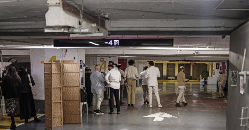 Jewish people pray inside an underground parking used as a shelter during the Passover holidays in Tel Aviv, April 7, 2026. (AFP Photo)