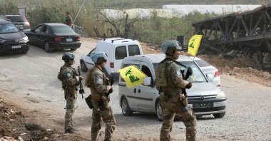 A French contingent of the United Nations Interim Force in Lebanon (UNIFIL) patrols the area as displaced residents waving Hezbollah flags make their way back to their homes on a makeshift road, built at the site where the Qasmieh bridge was destroyed in Israeli strikes, in the southern area of Al-Qasmiyeh, Lebanon, April 18, 2026. (AFP Photo)