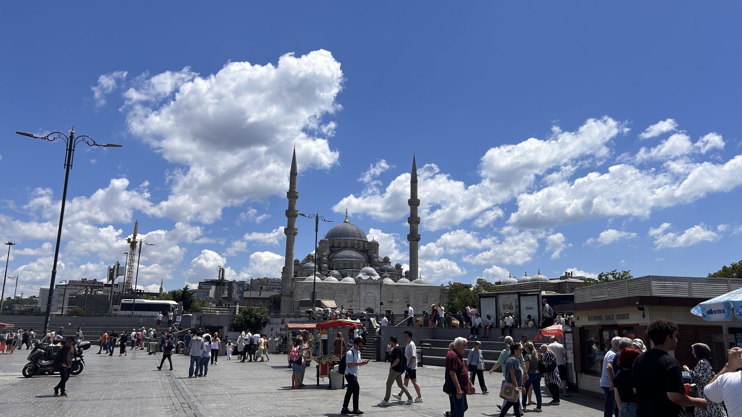 Yeni Mosque with crowded street creates a vibrant travel and tourism atmosphere, Istanbul, Türkiye, June 26, 2024. (Shutterstock Photo)