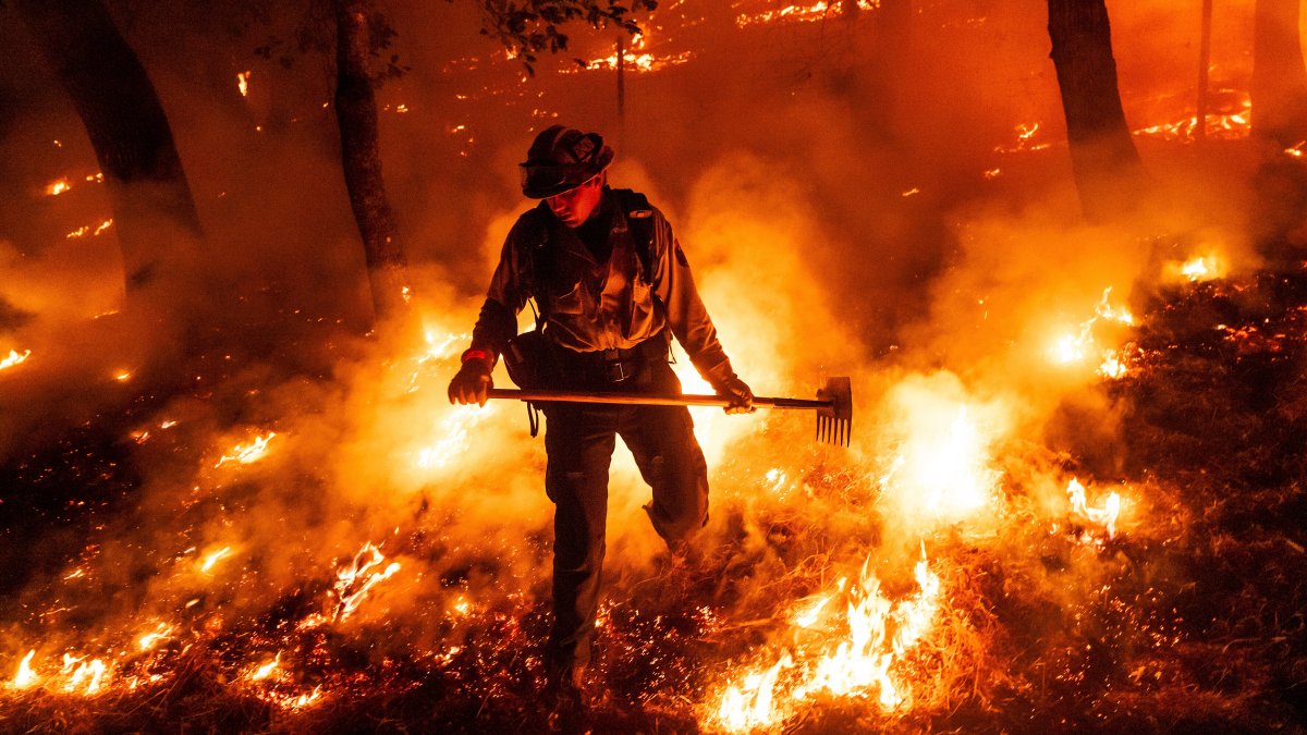 A firefighter battles the Pickett Fire burning in the Aetna Springs area of Napa County, Calif., U.S., Aug. 23, 2025. (AP Photo)