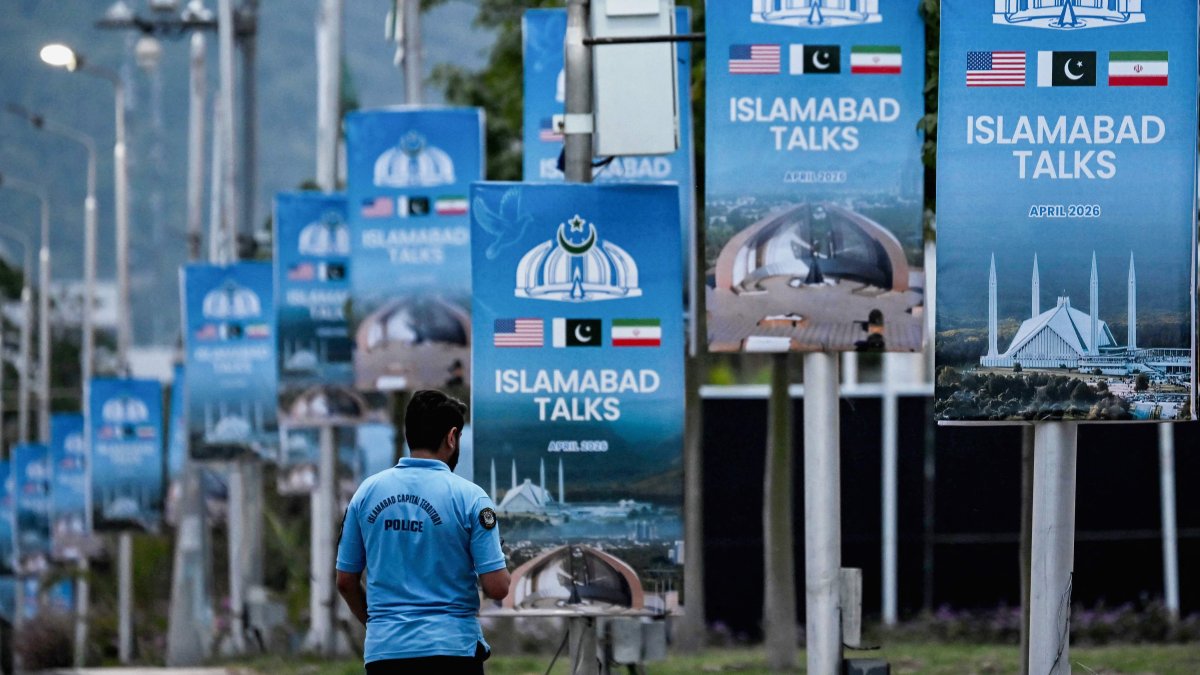 A policeman walks past posters highlighting Pakistan's mediation of Iran-U.S. peace talks, in Islamabad, Pakistan, April 18, 2026. (AFP Photo)