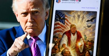 This photo illustration shows a picture of U.S. President Donald Trump on a screen, along with an AI-generated image he posted on his Truth Social platform depicting himself as Jesus Christ after criticizing Pope Leo XIV. (AFP Photo)