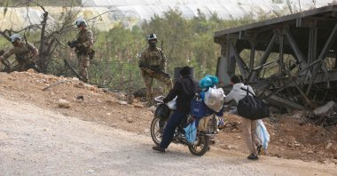 A French contingent of the UNIFIL patrols the area as displaced residents make their way home on a makeshift road, built at the site of Qasmiyeh bridge, which was destroyed in Israeli strikes, southern Lebanon, April 18, 2026. (AFP Photo)