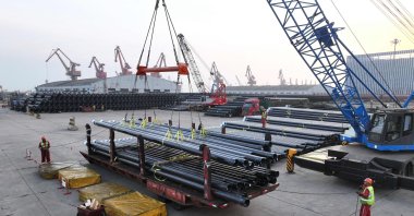 Workers load steel pipes for export at a port, Lianyungang, eastern China, March 27, 2026. (AFP Photo)