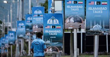 A policeman walks past posters highlighting Pakistan's mediation of Iran-U.S. peace talks, in Islamabad, Pakistan, April 18, 2026. (AFP Photo)