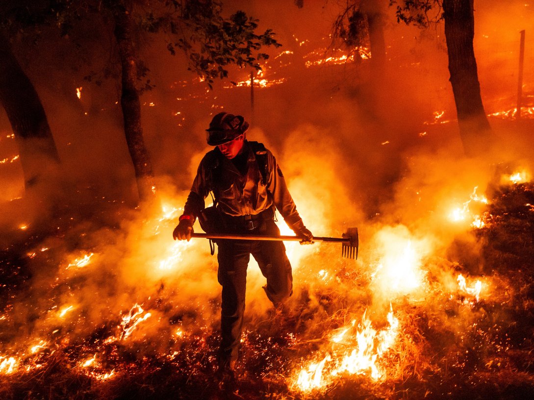 A firefighter battles the Pickett Fire burning in the Aetna Springs area of Napa County, Calif., U.S., Aug. 23, 2025. (AP Photo)
